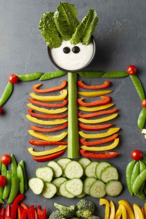 You'll have no problem getting your kids to eat their veggies when you present them in this fun, spooky way! Crudités make up the body of a fun skeleton for an easy Halloween party snack everyone will love. #halloween #halloweenparty #halloweeninspiration #recipe #eatingwell #healthy Skeleton Veggie Platter, Veggie Tray Halloween, Halloween Veggie Tray, Postres Halloween, Halloween Food Appetizers, Halloween Foods, Produce Stand, Healthy Halloween Snacks, Halloween Snack