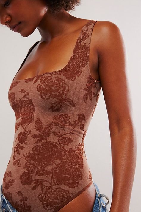 So comfy and chic, this floral-printed bodysuit is featured in Intimately’s signature seamless fabrication with a flattering square neckline and low scoop back. **Fit:** Form-fitting, thong bottom **Features:** Signature stretchy seamless fabrication, square neckline, thick straps, low scoop back, floral print **Why We | Send Love Seamless Bodysuit by Intimately at Free People in Brown, Size: M/L Plus Size Body Suit, Seamless Bodysuit, Send Love, Free People Bodysuit, Body Suit Outfits, Red Fits, Print Bodysuit, Boho Clothing, Square Neckline