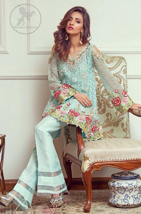 This outstanding self embroidered short frock embellished with floral thread embroidery. It is allured with resham, kora, dabka, tilla and pearls. Sleeves are decorated with cold shoulders design and floral embroidery. Scalloped hemline ornamented with tassels. It is beautifully paired up with matching bell bottom trouser. It comes with light blue dupatta sprinkled with sequins all over it. Bell Bottom Trouser, Pakistani Casual Wear, Mode Ab 50, Short Frocks, Bell Bottom Trousers, Heavy Dresses, Mode Hippie, Formal Wear Dresses, Pakistani Bridal Wear