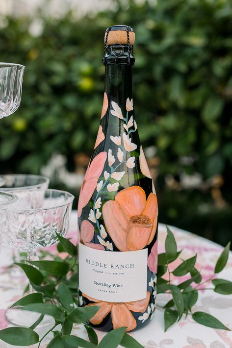 Bottle crush 🍾 here’s a close up for the little details that make a big impact — these hand painted bottles we create make the perfect keepsake for your special day. 🌸🤍🌿⁠
⁠
⁠
VENDOR DREAM TEAM:⁠
Planning & Design: @heydayweddings⁠
Photography and Cinematography: @slotownstudios⁠
Venue: @biddleranchvineyard⁠
Floral & Decor: @byrequestus⁠
Custom Signage: @roseandwrench⁠
Invitation Suite: @lookgoodonpaperco⁠
Hair & Makeup: @bellizzimobeauty⁠
Musician: @graybillmusic⁠ Painted Bottles, Hand Painted Bottles, Custom Signage, Bottle Painting, Sparkling Wine, Plan Design, Invitation Suite, Dream Team, Floral Decor