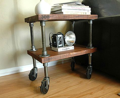 Thick wooden shelves, aged iron piping and stenciled numbers give this next item true character. Once again, casters allow for motion, which can be handy for a side table in a small space. Industrial Furniture Table, Industrial Vintage Decor, Meja Industrial, Industrial Pipe Furniture, Modern Industrial Furniture, Industrial Side Table, Vintage Industrial Decor, Industrial Design Furniture, Vintage Industrial Furniture