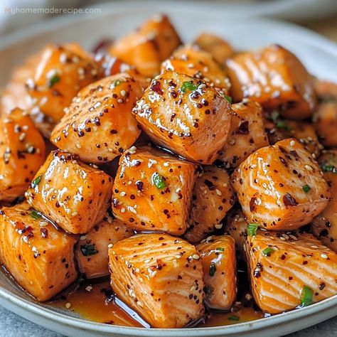 Air Fryer Salmon Bites are crispy on the outside, tender on the inside, and finished with a drizzle of sweet and spicy hot honey. These bites are perfect as an appetizer or main dish. Hot Honey Drizzle, Hot Honey Salmon Air Fryer, Honey Garlic Salmon Bites Air Fryer, Salmon Bits In Air Fryer, Recipes Using Hot Honey, Hot Honey Recipe Ideas, Salmon Bites Recipe Air Fryer, Spicy Salmon Bites, Hawaiian Bbq Sauce Recipe