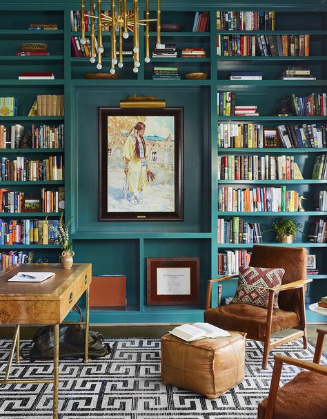 Turquoise bookcase with large artwork and gold chandelier in home workspace small wood desk and leather armchairs. Home Library Rooms, Home Library Design, Built In Bookcase, Murphy Bed, Home Library, Front Room, Home Office Design, Interior Design Firms, Guest Bedroom