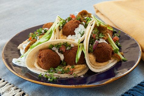 Our Mediterranean Falafel Tacos recipe is carefully crafted to make your next meal time extraordinary. Get the step by step instructions to make this delicious dish. Falafel Tacos, How To Make Falafel, Tzatziki Sauce, Mediterranean Dishes, Taco Recipes, Middle Eastern Recipes, Refried Beans, Middle Eastern, Tasty Dishes