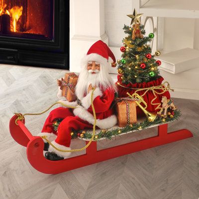 Add this darling Santa on sled with tree to your home this holiday season. This item is perfect as a gift for loved ones. It can also be used to spruce and entryway or add a joyful touch to the areas near the Christmas tree or fireplace. Using timer-operated LED -certified warm white lights this product is sure to brighten up any home this Christmas. This item uses 3AAA batteries. | The Holiday Aisle® Santa on Swith Tree Decorative Accent Resin in Red/White, Size 24.5 H x 11.0 W x 19.5 D in | Wa Tree Bed, Storing Christmas Decorations, Fun Christmas Decorations, Animated Christmas, Christmas Store, Christmas Centerpieces, Garden Crafts, Sled, Store Decor