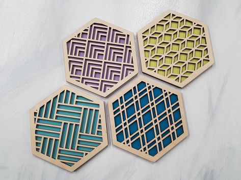 "Trivets for Hot Dishes. These trivets a beautiful accent for your table, they're also functional ones! The modern design will add a nice pop of fun to your décor while protecting your table. Sure to be a conversation starter and provide a little more style to your room. The beautiful geometric patterns are accented with a modern burst of color that will make them stand out in any home. Whether it's something special for yourself or a gift for a friend with a new home, you'll fall in love with t Coaster Design Painted, Laser Art Design, Laser Cut Gifts, Earth Tones Paint, Laser Cut Coaster, Laser Cut Designs, Geometric Coaster, Laser Cut Decor, Modern Coasters