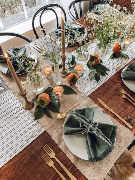 Whimsical dinning tablescape for the holidays using chamomile, persimmons and foraged foliage Holiday Table Decor, Plaid Blankets, Cozy Fall Decor, Harvest Thanksgiving, Seasonal Displays, Holiday Table Decorations, Holiday Table, Thanksgiving Table, Persimmon