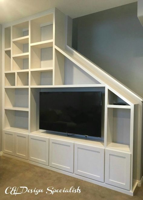 Tv Against Staircase Wall, Under Stairs Media Wall, Tv Staircase Wall, Tv Wall Design Under Staircase, Tv On Staircase Wall, Cottage Addition, Built In Wall Units, Custom Entertainment Center, Wall Entertainment Center