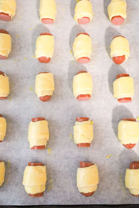 hot dog pieces wrapped in crescent dough and brushed with egg wash Pigs In A Blanket Hot Dogs, Hot Dog Pigs In A Blanket, Hot Dogs And Crescent Rolls, Hotdogs In Crescent Rolls, Weiner Wraps Crescent Rolls, Crescent Roll Hot Dog Recipes, Pillsbury Hot Dog Crescent Rolls, Hot Dog In Crescent Roll, Hot Dog Croissant