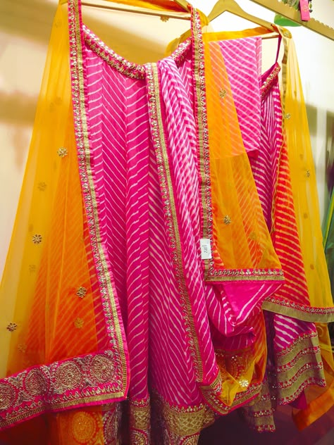 One of my favorites for a mehendi function. This gorgeous mango yellow orange with pink leheriya lehenga is the perfect pick this wedding season. #Frugal2Fab Jaipur Outfits Ideas, Jaipur Outfits, Lehenga Choli For Navratri, Rajasthani Lehenga, Choli For Navratri, Rajasthani Dress, Mehendi Outfits, Bandhani Dress, Yellow Lehenga