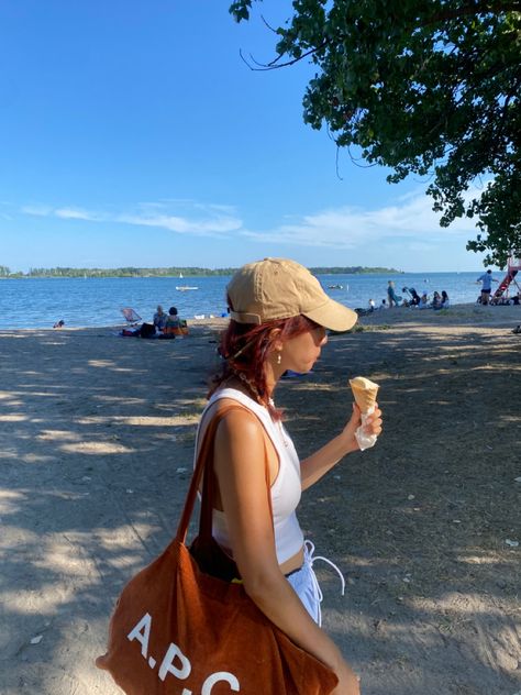 A girl standing in front of water holding an ice cream wearing a hat and a white tank top Beach Hat Outfit, Beach Hats Outfit, Backwards Baseball Cap, Summer Hats Beach, Hat Outfit, Hat Baseball, Summer Hat, Outfits With Hats, Beach Hat