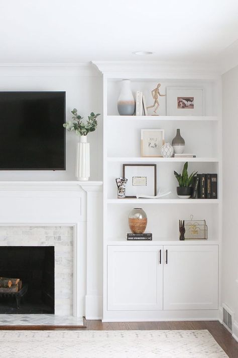 White open bookcases next to fireplace, marble subway tile, shelf styling, how to style shelves, tv mounted above fireplace, neutral room, neutral rug, Classic Grey Living Room, Hamptons Fireplace, Decorating Built In Shelves, Bookcase Fireplace, Coastal Styling, Fireplace Bedroom, White Built Ins, Built In Around Fireplace, Fireplace Bookshelves