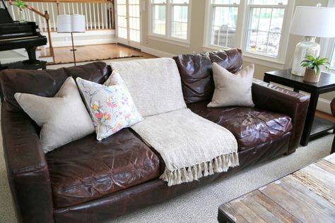 Styling Your Brown Leather Sofa - The Decorologist - The Decorologist Leather Sofa Throw Ideas, Dark Brown Leather Sofa Styling, Throw Pillows For Dark Brown Leather Couch, How To Decorate Around A Dark Brown Leather Couch, How To Style Brown Leather Sofa, Styling Dark Brown Leather Couch, Leather Couch Cottage Style, Style Brown Leather Couch, Pillows For A Brown Leather Couch