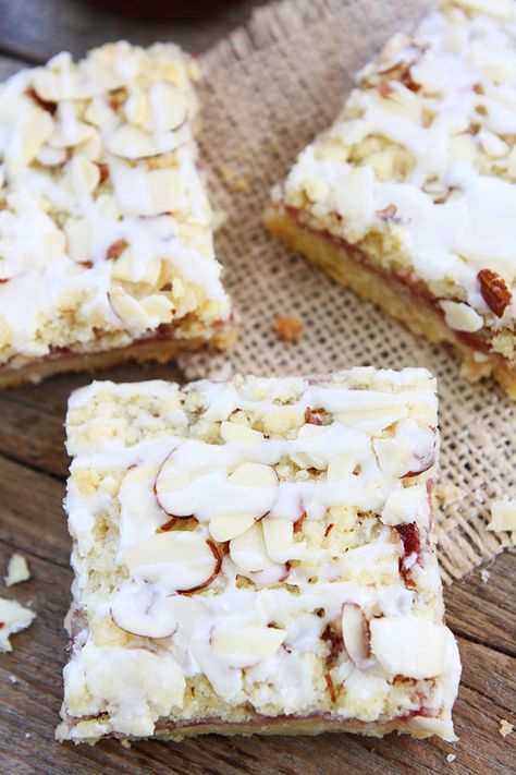 Raspberry Almond Shortbread Bars Recipe on twopeasandtheirpod.com Buttery shortbread bars with raspberry jam, almond streusel, and a sweet almond glaze! Almond Shortbread Bars, Raspberry Shortbread Bars, Shortbread Bars Recipes, Jam Bars, Savory Baking, Almond Shortbread, Almond Shortbread Cookies, Raspberry Bars, Almond Bars