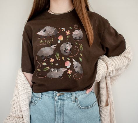 Cute Cottagecore Possum Gift for people that are opossum fans or opossum lovers and for cottage core aesthetic lovers. Add this super soft Cottagecore Clothing to your Aesthetic clothing collection. Available on tshirt, sweatshirt and hoodies: https://www.etsy.com/shop/TheNims?search_query=possum For other Christmas items, click here: https://www.etsy.com/shop/TheNims?r&section_id=30682947 Browse through my other awesome items here: http://thenims.etsy.com/ UNISEX TEES Gildan 5000™ (CUSTOMER FAV Cottage Core Christmas Shirt, Possum Shirt, Cottage Core Clothes, Soft Cottagecore, Aesthetic Lovers, Cottage Core Shirt, Christmas Kawaii, Cute Cottagecore, Cottage Core Aesthetic