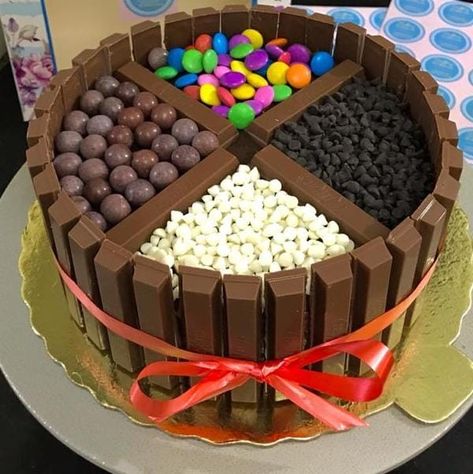 *Kitkat gems cake* is a fudgy ganache and frosted with chocolate buttercream cake topped with gems, white chocolate, dark chocolate shots, and surrounded by Kitkat. *Perfect cake for birthday and anniversary celebrations*🥳🥳 Call us@ 📞 *9671586866* Gems Cake, Chocolate Kit Kat Cake, Chocolate Buttercream Cake, Gem Cake, Cake For Birthday, Kitkat Cake, Chocolate Shots, Kit Kat Cake, Chocolate Cake Designs