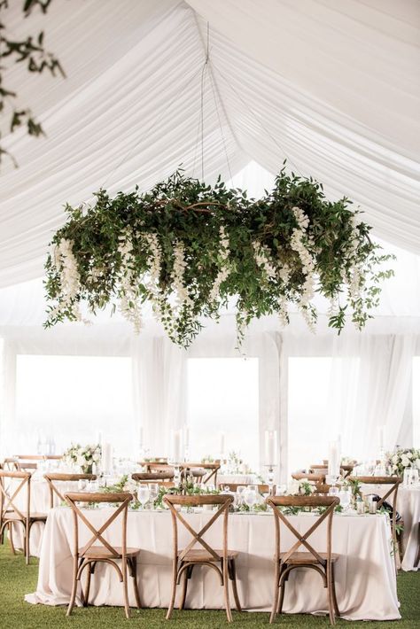 Hanging Greenery Chandelier, Smilax Chandelier Wedding, White Flowers Hanging From Ceiling Wedding, Hanging Wedding Floral Installations, Florals Hanging From Chandelier Wedding, Flowers Hanging From Chandelier Wedding, Floral Hanging Wreath Flower Chandelier, Enchanted Wedding Arch, Hanging Floral Chandelier Wedding