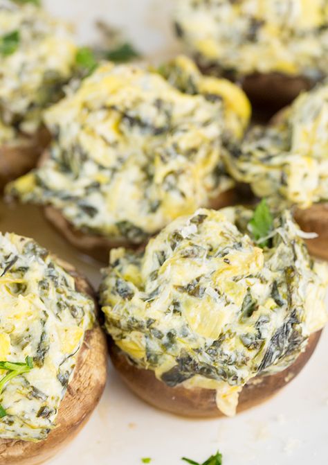 Cheesy Artichoke and Spinach Stuffed Mushrooms bring together everything you love about Artichoke and Spinach dip but stuffed into mushrooms! Low-carb and keto friendly. Spinach Artichoke Dip Stuffed Mushrooms, Spinach Artichoke Mushrooms, Mushroom Spinach Appetizers, Spinach Artichoke Stuffed Mushrooms, Artichoke Stuffed Mushrooms, Keto Stuffed Mushrooms, Artichoke And Spinach Dip, Baked Stuffed Mushrooms, Artichoke And Spinach