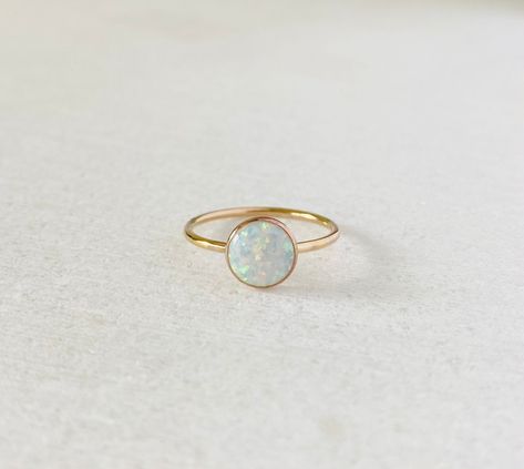 This ring comes with a large man made 8mm sparkling white opal. Available in gold filled, sterling silver or 14k solid yellow gold. Band: 1.3mm Opal is October birthstone. Solitaire Opal Ring, White Gold Opal Ring, Gold Ring Band, Birthday Gemstones, Opal Stacking Ring, Opal Solitaire Ring, Solid Gold Charms, Dot Ring, White Opal Ring