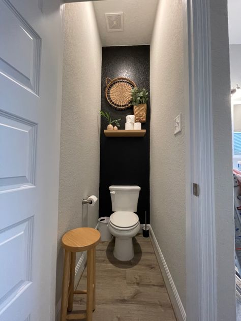 Black And Wood Toilet, Behind Toilet Accent Wall Paint, Half Bath Accent Wall Ideas Paint, Above Toilet Decor Boho, Restroom Accent Wall, Bathroom With Black Accent Wall, Bathroom Accent Wall Behind Toilet, Toilet Accent Wall, Accent Wall Behind Toilet