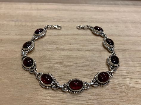 Lovely garnet and sterling silver bracelet. The bracelet has 9 individual garnet in an oval shape.  The bracelet measure 21 cm long and it is almost 0.8 cm wide. The bracelet can be  easily  adjusted from 21 cm to 17 cm.  The high quality of our stones is what it makes this bracelet so precious.  A perfect present for her on any occasion St Valentine Day, Birthday, Anniversary, Travelling or Christmas. Your bracelet will be pack in our lovely Kallpa bag. If the destination is outside UK the pack St Valentine, Edgy Jewelry, Red Bracelet, Garnet Bracelet, Red Bracelets, Dope Jewelry, Garnet Jewelry, Bracelet Chain, Jewelry Lookbook