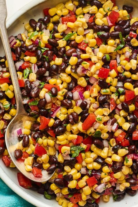 Serving bowl with black bean and corn salad. Spoon is in the bowl. Healthy Cookout, Grill Veggies, Corn And Bean Salad, Salad Board, Cookout Dishes, Black Bean And Corn Salad, Bean And Corn Salad, Black Bean Corn Salad, Bean Salads