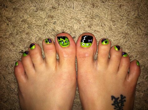 Halloween Toes DIY at home with Frankenstein and this year I added his bride.  Green and purple with black spiders and stitches. Done at the Rockhold House Frankenstein Toenails, Halloween Toes Nails, Halloween Toes Nails Design, Nails Design Purple, Purple And Green Halloween, Halloween Toe Nails, Halloween Toes, Black Spiders, Toenail Art