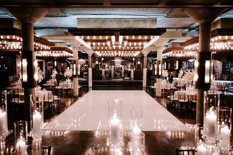 The industrial chic venue, The Astorian, decorated with a white dance floor and candles. Romantic Reception, Family Style Table, Romantic Ceremony, White Floral Arrangements, Wedding Venue Houston, Sparkler Send Off, Elegant Table Settings, Reception Signs, Romantic Lighting