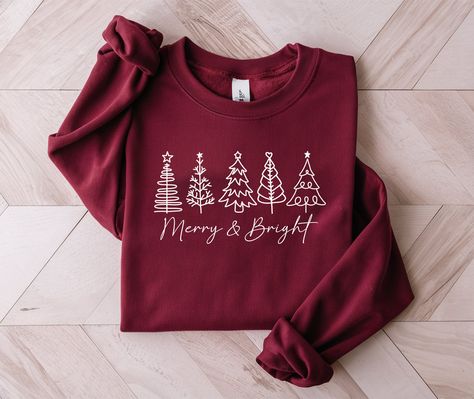 Cozy up this holiday season with our "Merry and Bright" Christmas Tree Sweatshirt, the perfect festive addition to your wardrobe. Whether you're celebrating in a classic Christmas Tree Shirt or a cozy Holiday Sweatshirt, these Christmas Shirts will keep you warm and stylish all winter long. 🎄  🎄 🎄  🎄 'Tis the season to sparkle and shine! 🌟 Get ready to cozy up with our "Merry and Bright" Christmas Tree Sweatshirt! ✨ Embrace the holiday cheer with our festive sweatshirts, perfect for celebra Christmas Sweatshirt Ideas, Merry And Bright Christmas Tree, Christmas Sweater Ideas, Bright Christmas Tree, Christmas Crewneck Sweatshirt, Classic Christmas Tree, Christmas Tree Shirt, Cozy Holiday, Bright Christmas