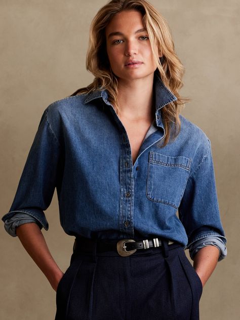 Cut with ease and crafted from lightweight denim, this oversized shirt has high slits at the sides to show off high-waisted styles.  OVERSIZED FIT: Cut for a loose, relaxed fit with a dropped shoulder.  Point collar.  Troca shell button front.  Chest Dark Denim Shirt Outfit, Blue Denim Shirt Outfit, Oversized Denim Shirt Outfit, Oversized Button Down Shirt Outfit, Denim Shirt Outfit Women, Denim Shirt Women, Plan 2023, Dark Denim Shirt, Denim Shirt Outfit