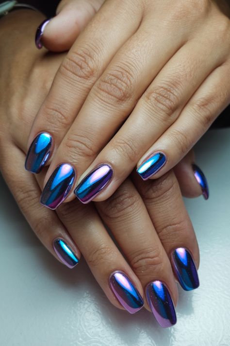 Step into the season with these eye-catching metallic fall nails! This stunning nail design combines bold chrome shades of blue and purple, perfect for adding a touch of glamour to your fall fashion. Whether you're dressing up for a special occasion or elevating your everyday look, these fall nails are sure to turn heads. Pin this now to inspire your next trendy manicure and keep your fashion game strong! Holiday Nails Chrome, Metallic Blue Nail Designs, Dark Purple Nails With Chrome, Dark Purple Chrome Nails Designs, Metallic Purple Nail Designs, Chrome Purple Nails, Chrome Nails Blue, Blue And Purple Nails, Chrome Nails Blue Purple