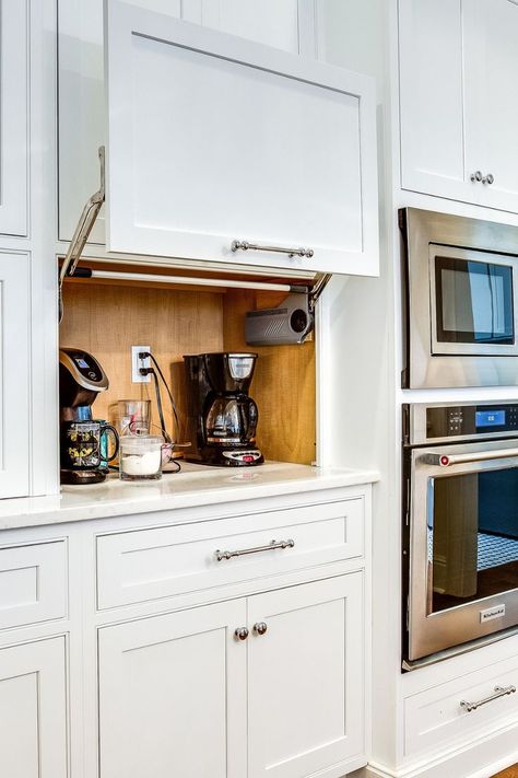 A compact appliance garage nestled on a kitchen countertop, featuring a roll-up door. The interior is equipped with space for storing small kitchen appliances like a toaster, blender, and coffee maker, and electrical outlets so the appliances can stay plugged in for easy use. Built In Kitchen Gadgets, Kitchen Appliance Shelf, Kitchen Storage Appliances, Garage Appliance Cabinet, How To Hide Air Fryer In Kitchen, Hiding Kitchen Appliances, Smart Kitchen Appliances, Kitchen Small Appliance Storage Ideas, Kitchen Appliances Cabinet