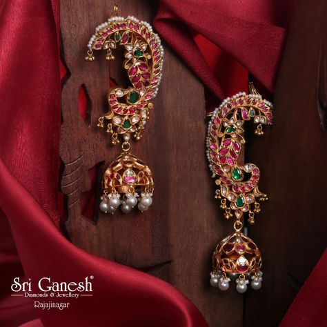 Exquisite traditional jhumka earrings adorned with vibrant rubies, emeralds, and pearls, beautifully crafted to enhance your ethnic charm. Timeless Treasures 🪔 Shop the Collection: 📍 : 335 1st 'N' Block, Near Vidya Vardhaka School, Rajajinagar, Bangalore-560010 📱 Call/Whatsapp:   9845479000 / 9845212200/  9606777598 Shop online at  www.sriganesh.live Email: info@sriganesh.com #SriGaneshDiamondsAndJewellery #Rajajinagar #AssuredGifts #FineJewellery #Gold #Diamonds #Platinum #polkijewel... Ear Cuffs Gold Indian, Deity Jewellery, Big Earrings Gold, Traditional Jhumka, Vintage Indian Jewelry, Bridal Jewellery Earrings, Antique Gold Earrings, Neck Pieces Jewelry, Indian Jewelry Earrings