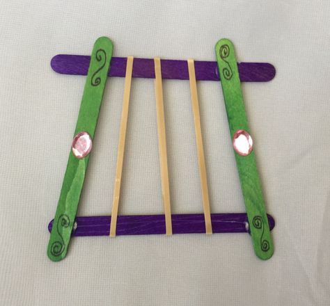 Popsicle stick rubber band harp for worship themed craft. Hot glue Popsicle sticks ahead of time. Have kids color with markers, apply jewel stickers and rubber bands. (Awana Cubbies Bear Hug #7 Honeycomb handbook) Harp Craft, Noah's Ark Popsicle Stick Craft, Worship Crafts For Kids, David Harp Craft, Feast Of Trumpets Crafts For Kids, God's Eye With Popsicle Sticks, David And Goliath Craft, Awana Cubbies, Bible Story Crafts