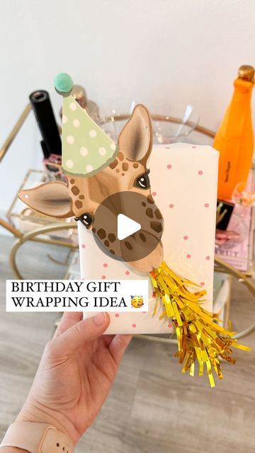 Shelby | Gift-in-a-Box Guide on Instagram: "YOU’RE NOT READY FOR HOW CUTE! 🥳🎁🦒  Comment ZHUZH for the animal garland & everything else I used to wrap this gift!   This is a new way to use the cute party horns for gift wrapping! Just grab a cute animal garland / cutout and add the blower using hot glue or foam tape to secure it   The garland came with 20 die cut animals and the party horns come in a pack of 6 so you can easily rinse and repeat this same method for a bunch of gifts!   I also ended up adding some letter beads to the top right corner for the name which made it even cuter  An easy way to create a Pinterest-esque gift! ✨  What should we name him?!?  #birthday #birthdaygifts #bdaygift #birthdaygiftideas #giftwrappingideas #giftwrapping #giftwrappinginspiration #giftwrappingins Animal Wrapping Ideas, Unicorn Gift Wrapping Ideas, Stuffed Animal Gift Wrapping Ideas, Fun Ways To Wrap Birthday Gifts, Animal Gift Wrapping Ideas, Present Wrapping Ideas Birthday, Letter Packing Ideas, Fun Birthday Wrapping Ideas, 1st Birthday Gift Wrapping Ideas