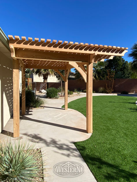 This stunning timber frame arbor with a natural wood cantilevered roof gracefully covers a winding sidewalk, creating a tranquil resting space along the path. Wood Pergola Kits, Privacy Trellis, Design Manager, Cafe Rio, Wood Pergola, Garden Arbor, Design Management, Organic Wood, Wood Tones