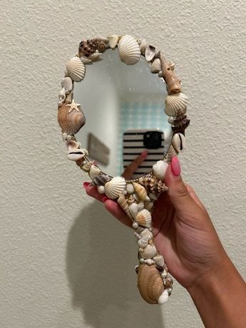 mirror covered in shells, starfish, and fake pearls Sea Shell Mirrors Seashell Frame, Shell Mirrors, Seashell Frame, Seashell Mirror, Seashell Projects, Mirror Frame Diy, Shell Mirror, Mermaid Diy, Winter Park Fl