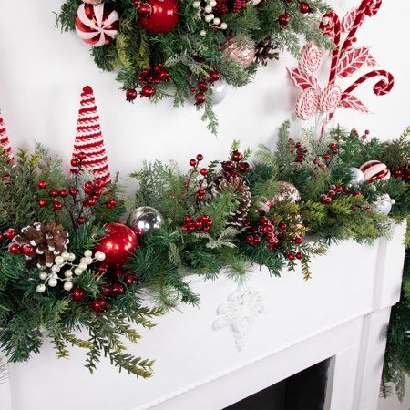 Bring the magic of the holiday season into your home with our artificial Christmas garland. Adorned with pinecones, festive ornaments, and vibrant berries, this garland sparkles with glitter accents. Perfect for draping over mantels, banisters, or doorways, its lush, realistic greenery and thoughtful decorations create a warm and inviting holiday atmosphere. Celebrate the season with this beautifully crafted garland, designed to make your home feel festive and cozy. Product Features: Unlit. Deco Holly Christmas Decorations, Indoor Christmas Garland, Farmhouse Christmas Garland, Red And White Ornaments, Christmas Garland Ideas, Garland Christmas Decor, Peppermint Ornament, Holiday Mantle, Faux Christmas