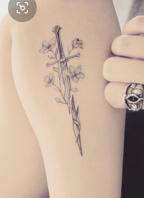 Hadhafang Tattoo, Lord Of The Rings Flowers, Lowkey Tattoos, Narsil Tattoo With Flowers, Lotr Flowers Tattoo, Small Lord Of The Rings Tattoo, Feminine Lotr Tattoo, Shards Of Narsil Tattoo, Lotr Spine Tattoo