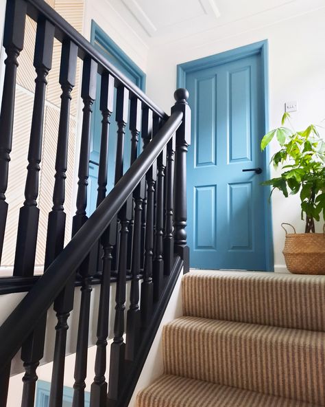 Create an eye-catching design by painting your doors and frames a bold colour. Doors and frames painted in Farrow and Ball Stone Blue and banister and spindles painted in a mix of Frenchic Aftermidnight and Blackjack. Frenchic Blackjack Stairs, Navy Blue Bannister, Farrow And Ball Stone, Colourful Hallway, Blue Staircase, White Banister, Painted Banister, Blue Painted Door, Stairway Ideas