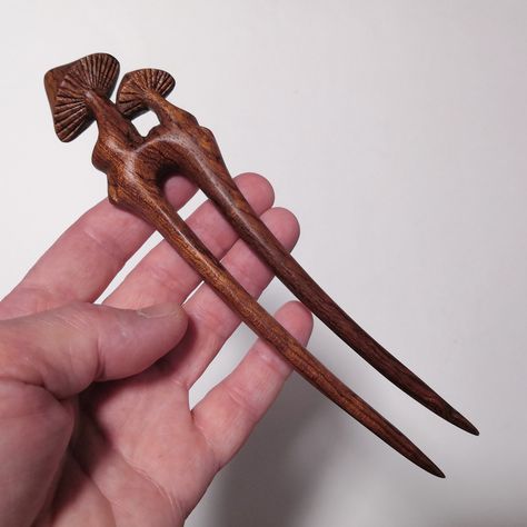 Carved wooden hair fork with mushrooms. Wooden hairpin with two teeth. This hairpin is carved from precious bubinga (African rosewood) wood. The wood has a beautiful color and unusual texture. Also, this wood is very durable, which guarantees the reliability of the product. Well, a hairpin is always a great gift for a girl with long hair. Dimensions: Overall length 7 inches, prong length 5 inches, at the widest point 1.5 inches. You can wear it under the sun and rain, wipe it with a cloth, do no Hair Pin Wood, Wooden Hair Pins, Wooden Hair Chopsticks, Wood Hair Sticks, Wooden Hair Sticks Handmade, Chinese Wooden Hairpin, Hand Carved Wooden Hair Pins, Wooden Hair Sticks, Hair Forks