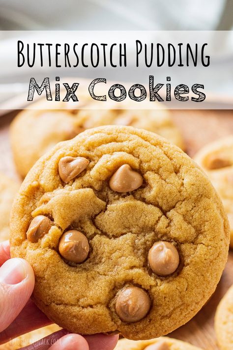 Hand holding baked butterscotch cookie Butterscotch Pudding Cookies Recipes, Chewy Butterscotch Cookies, Butterscotch Pudding Mix Recipes, Butterscotch Chip Desserts, Butterscotch Pudding Desserts Easy, Easy Butterscotch Desserts, Cookies With Pudding Mix In Them, Butterscotch Chip Recipes, Pudding Mix Cookies