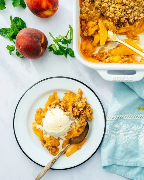 Perfect Peach Crisp – A Couple Cooks Oatmeal Pudding, Gluten Free Peach Crisp, Peach Pie Bars, Gluten Free Crisps, Peach Oatmeal, Baked Rice Pudding, Peach Crisp Recipe, Peach Crumble, Southern Plate