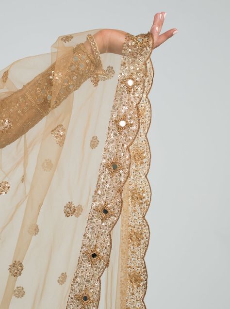 Once Upon A Time Collection. Soft Net. Mirror Work. Hand Embroidery. The Caramel Cinema Dupatta encompasses timeless mirror work nested within gold hand sewn beads on the scalloped border. This shimmering fabric has sequins detailing spread throughout the soft net for added texture. Standard Dupatta: 42 in x 95 in Mirror Work Dupatta, South Asian Fashion, Abhinav Mishra, Scalloped Border, Indian Aesthetic, Gold Hand, Gold Hands, Mirror Work, Blouse Length