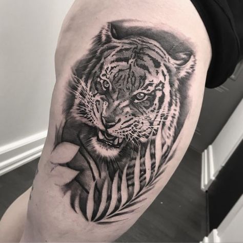 25 Tiger Tattoo on Thigh Ideas Tiger Leaf Tattoo, Tiger Tattoo On Thigh, Tiger Thigh Tattoo, Thigh Sleeve Tattoo, Tiger Tattoo Thigh, Thigh Tattoo Ideas, Tattoo On Thigh, Tiger Silhouette, Tiger Tattoos