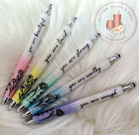 This listing is for our new custom pastel glitter pens with inspirational quotes. These pens are sold either individually or as a complete set of 5 pens. Our pens are all refillable and each comes with an additional refill. Each pen/set is made to order using a stainless steel base, painted and glittered using quality glitter before being decaled and sealed. Each pen also comes complete with a built in stylus for us with your smart phone or tablet. These pens are available in the following quote Glitter Pen Sayings, Inspirational Glitter Pens, Glitter Ink Pens, Nurse Pens Epoxy, Custom Glitter Pens, Epoxy Glitter Pens, Resin Pen Ideas, Glitter Pen Ideas, Glitter Pens Epoxy Ideas