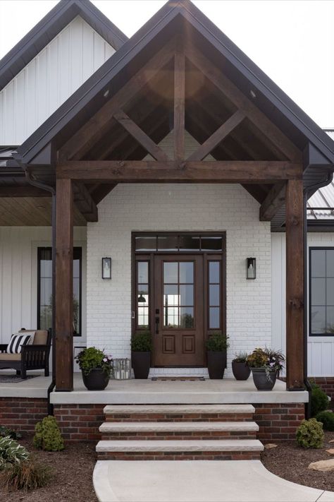 This home has a beautiful front door and porch. The large timber beams look stunning with the white exterior. White Siding Exterior, Front Porch Entrance, Porch Beams, Covered Front Porch, Porch Entrance, Craftsman Exterior, Timber Beams, Porch Steps, Bungalow House Plans