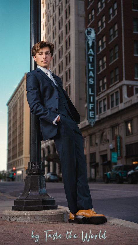 A senior boy in downtown Tulsa. He's wearing a cool blue suit and leaning on a light post with his hands in his pockets. He looks relaxed and cool. Male Clothing Model Poses, Prom Photos Guys, Dressy Senior Pictures, Men Poses Photography Ideas Photo Shoot, Senior Picture Ideas For Guys Downtown, Guy Leaning On Wall, Senior Portraits Boys Posing Ideas, Suit Senior Pictures, Senior Pictures Suit