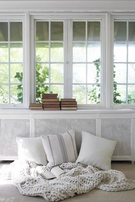 reading nook- This fall, create a makeshift reading nook with a cozy throw blanket and pillows. White tones help to keep the design minimal! Radiator Cover Ideas, Comfy Decor, Interior Design Secrets, Ford Interior, Paint Cabinets White, Fall Decor Ideas, Hamptons House, Radiator Cover, Cover Ideas