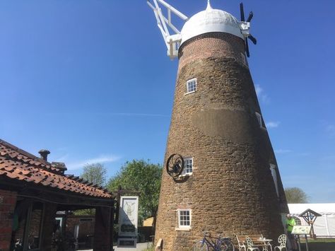 Wymondham Windmill, Wymondham, nr Melton Mowbray, Leicestershire, UK, is a five-story tower mill, built c. 1814 from local ironstone and topped with brick. It has an ogee cap and fantail. The Mill ceased grinding corn in 1952 but continued with cattle feed until 1960. It is one of only four six-sailed windmills remaining in the country and is Grade 2 listed. Ancient Kings, Melton Mowbray, Timber Frame Building, Cattle Feed, Heritage Railway, Perfect Days, Tiny Village, Country Park, Tourist Trap